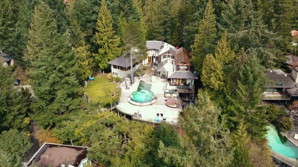 Interlock aluminum Tudor Brown slate metal roof on a home in West Vancouver, BC — the completed installation featured in the homeowner's video testimonial.