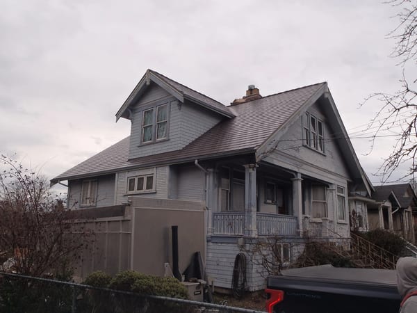 Tudor Brown Interlock Cedar Shingle aluminum roof on a Tudor home with a metal roof in an urban setting, Victoria, British Columbia