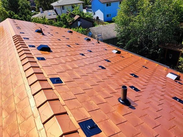 Copper Penny Interlock Slate aluminum roof on a brown single-family home with a copper penny metal roof, Victoria, British Columbia
