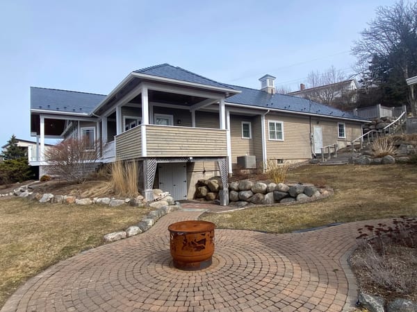 Deep Charcoal Interlock Slate aluminum roof on the home with chimney, Lunenburg, Nova Scotia