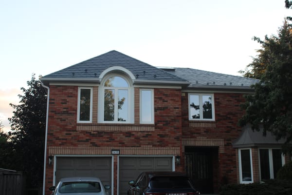Two-storey brick Colonial home in Oakville with Interlock deep charcoal aluminum slate metal roof featuring multi-hip profile and snow guards.