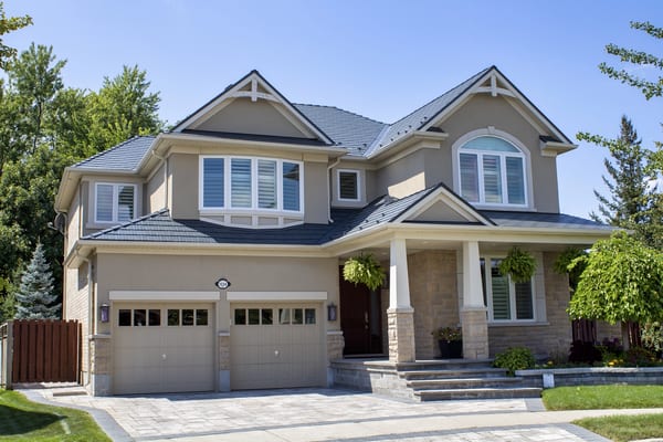 Two-storey Craftsman home in Milton ON with Interlock deep charcoal cedar shingle metal roof featuring multiple dormers, complex hip lines, and covered front porch.