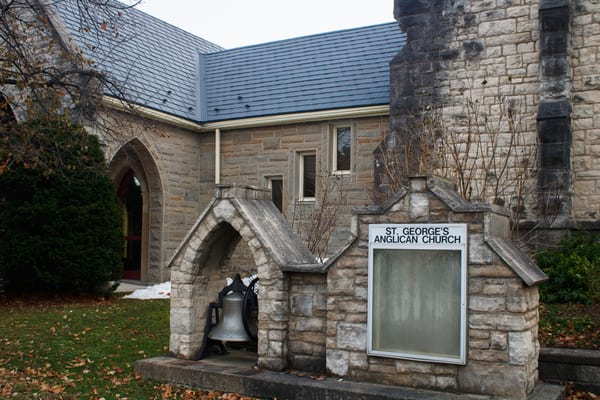 St. George's Anglican Church in Owen Sound, ON, with deep charcoal Interlock aluminum slate roofing on a steep multi-pitch stone heritage building.