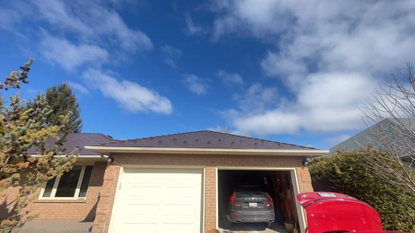 Single-storey brick ranch home with Interlock Colonial Brown cedar shingle metal roof, hip profile, double garage, Bradford ON.