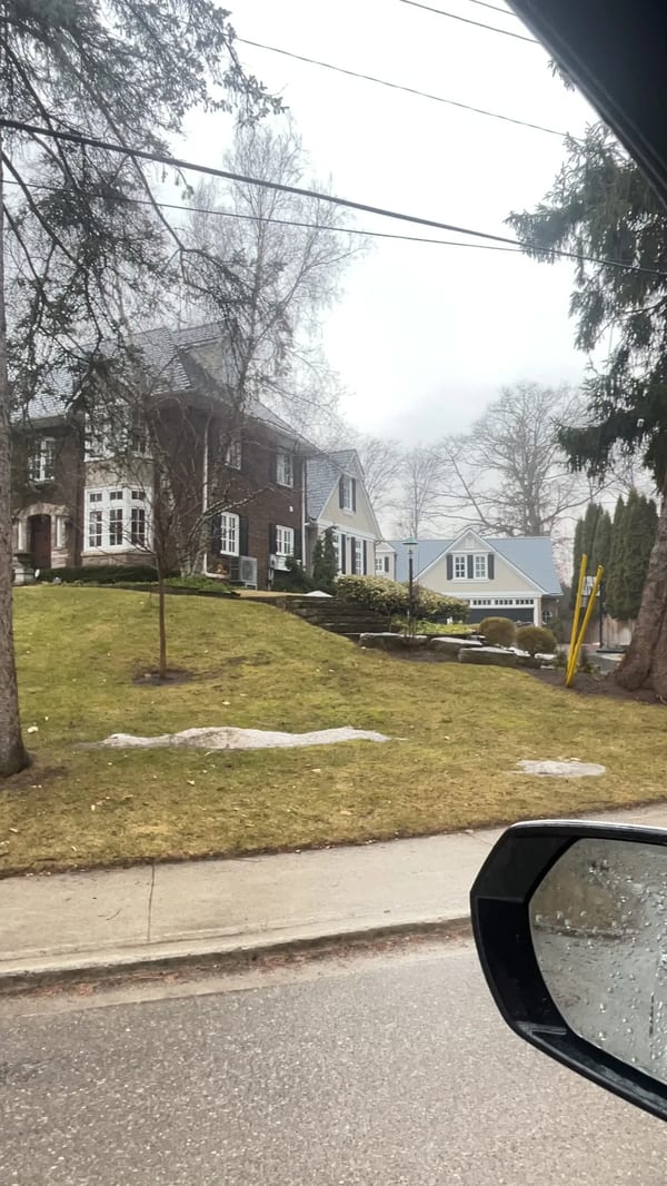 Deep Charcoal Interlock Slate aluminum roof on a two-storey home with dormers among tall pines, Burlington, Ontario