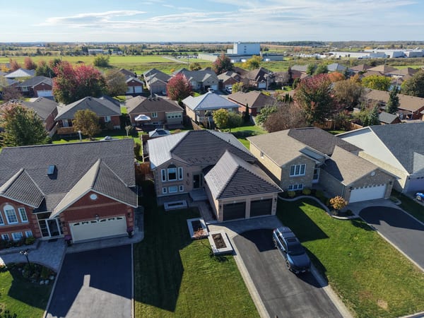 Tudor Brown Interlock Slate aluminum roof on a Tudor-style house with a brown metal roof in a rural area, Lindsay, Ontario