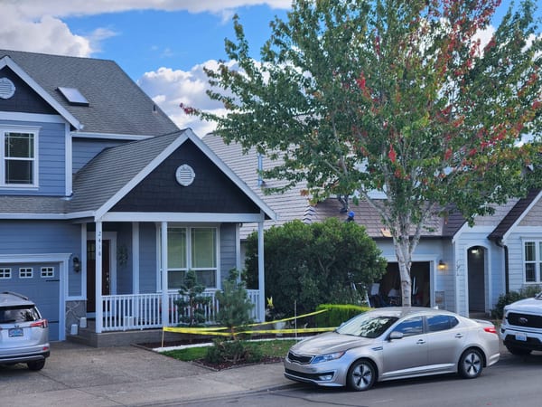 Street view of a two-story Craftsman home in Gresham, OR featuring Interlock aluminum slate roofing in Colonial Brown with complex multi-plane roof geometry.