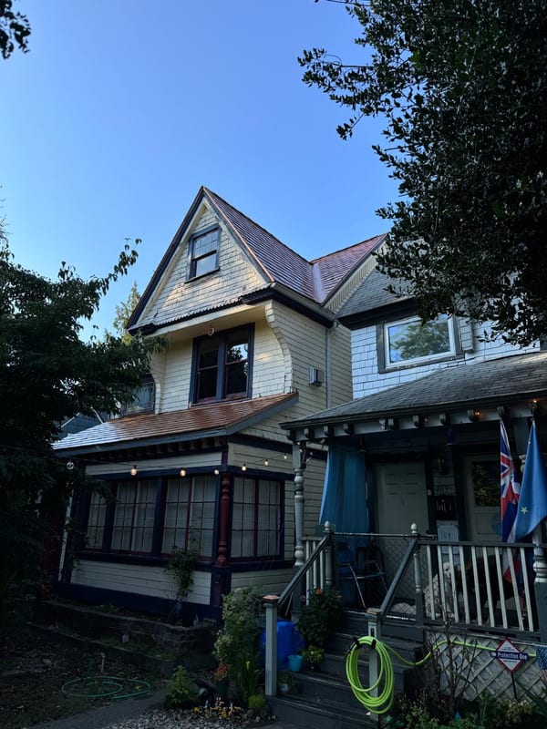 Victorian home in Tacoma, WA with Interlock aluminum slate roof in Copper Penny, featuring a steep multi-gable dormer and complex roofline.