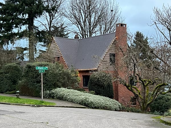 Deep Charcoal Interlock Slate aluminum roof on a two-storey home with a metal roof in a forested urban, Seattle, Washington