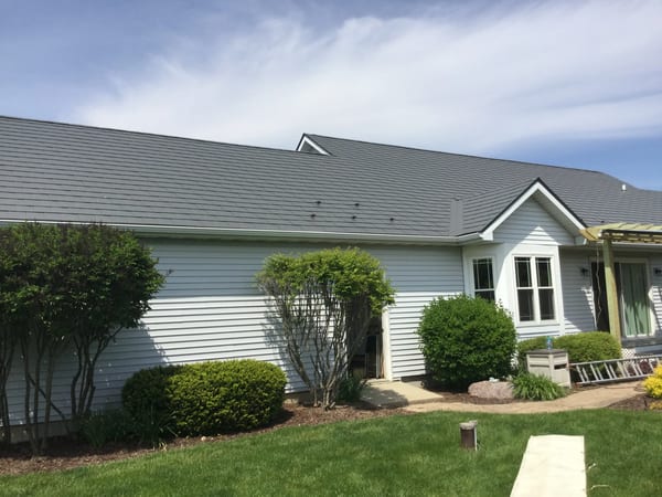 Tudor Brown Interlock Slate aluminum roof on a white two-storey Tudor home with dormers in a rural, Burlington, Wisconsin