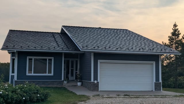 Colonial Brown Interlock Shake aluminum roof on a colonial-style home with a Colonial Brown metal roof in a, Crooked Creek, Alberta