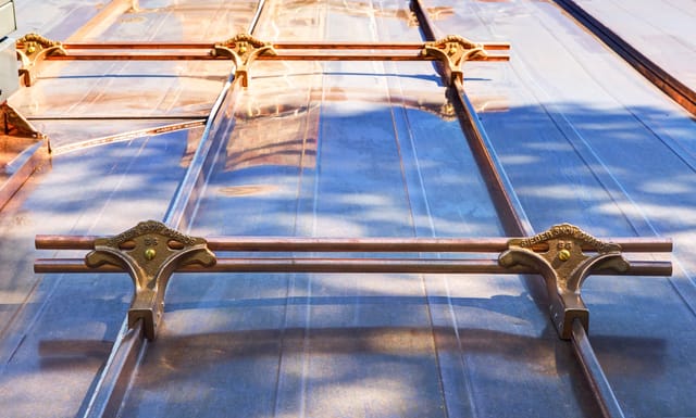 Solid copper Interlock Standing Seam roof on a one-storey home with a hip roof in a rural setting, Antigonish, Nova Scotia