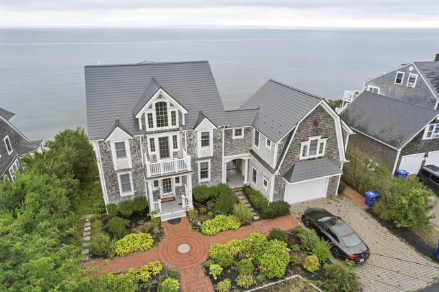 Gray Interlock aluminum roof on a shingle-sided home overlooking the ocean