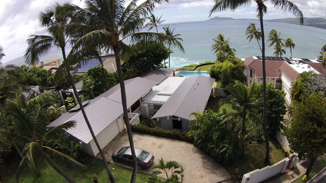Interlock metal roof on an oceanfront home surrounded by palm trees