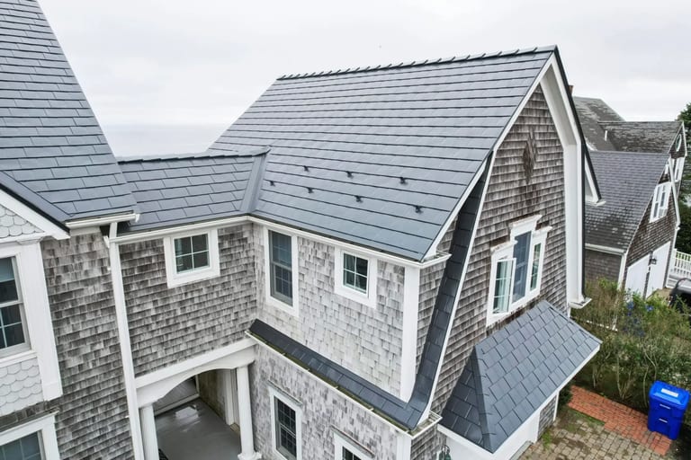 Close-up of a metal drip edge installed along the eave of a metal roof
