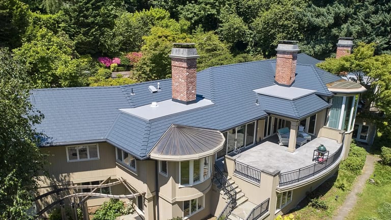 A selection of metal roof styles — standing seam, slate, shake, and tile — on residential homes