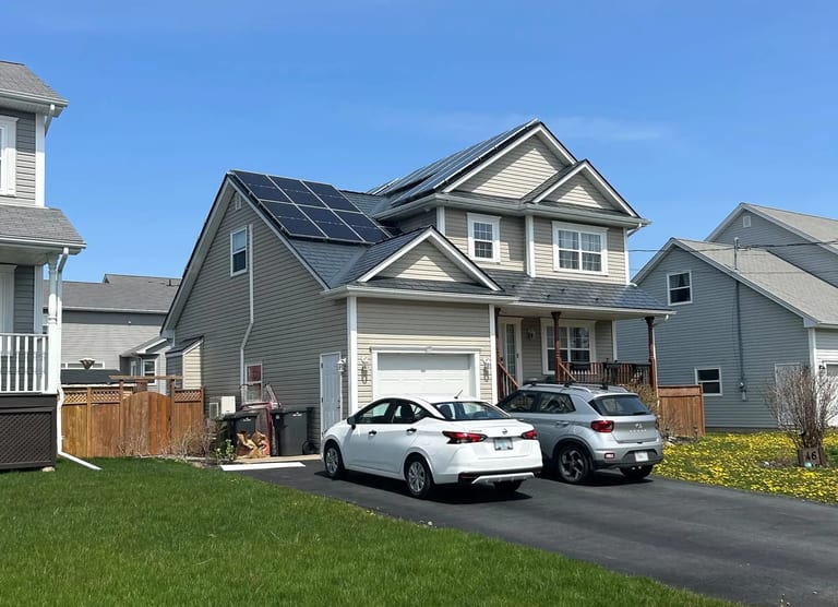 Home with photovoltaic solar panels mounted on an Interlock metal roof