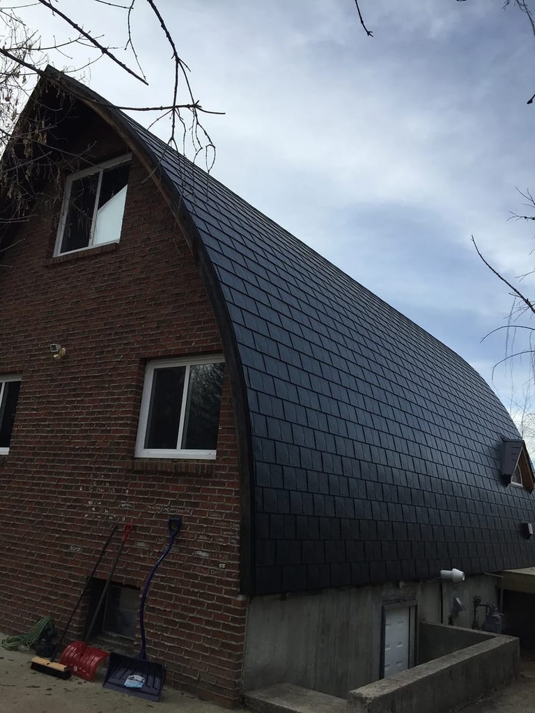 Black Interlock Slate aluminum roof on a brown home with a black metal roof in a rural setting, Whitecourt, Alberta