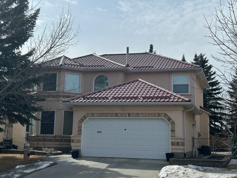 Tile Red Interlock Tile aluminum roof on a tan house with a tile red metal roof in Calgary, Alberta, Calgary, Alberta
