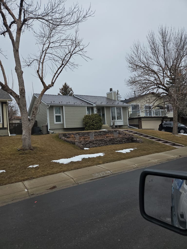 Tudor Brown Interlock Slate aluminum roof on a Tudor brown metal roof on a single-storey home in a, Calgary, Alberta