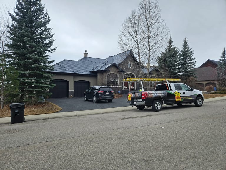 Deep Charcoal Interlock Slate aluminum roof on a two-storey home with a metal roof in a residential area, Calgary, Alberta