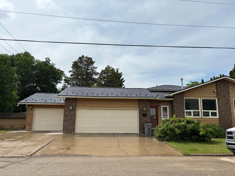 Black Interlock Slate aluminum roof on a brown ranch home with a metal roof in a rural suburban, Grande Prairie, Alberta