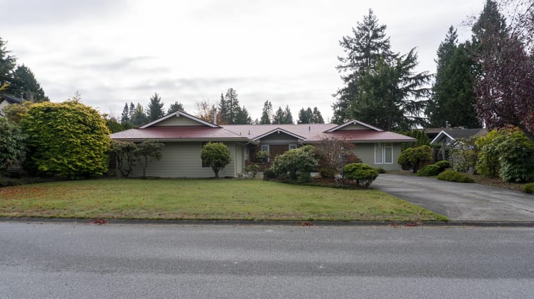 Tile Red Interlock Slate aluminum roof on a ranch style home with a tile red roof in a suburban, Delta, British Columbia