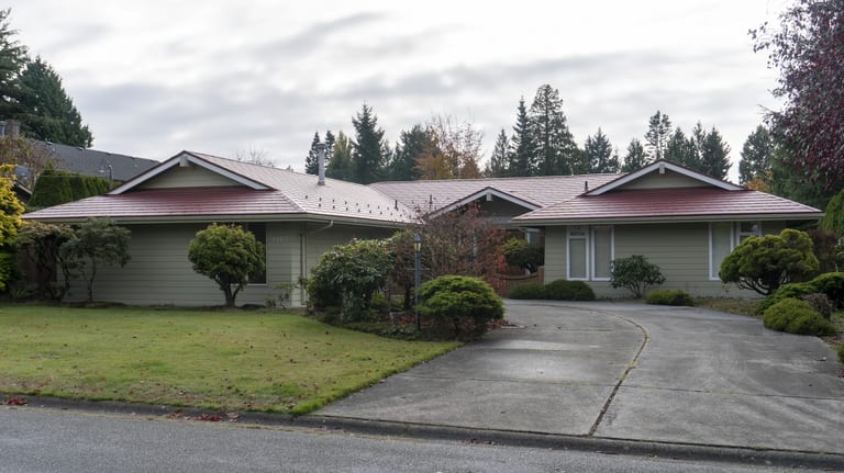 Tile Red Interlock Slate aluminum roof on a ranch home in a suburban setting with lush greenery, Delta, British Columbia