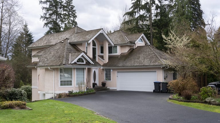 Before: Before: a leaking wood shake roof on the home, Port Coquitlam, British Columbia, ahead of a Weathered Interlock Slate aluminum roof