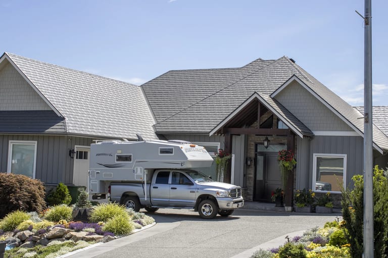 Deep Charcoal Interlock Slate aluminum roof on a grey single-family home with a metal roof in a suburban, Abbotsford, British Columbia