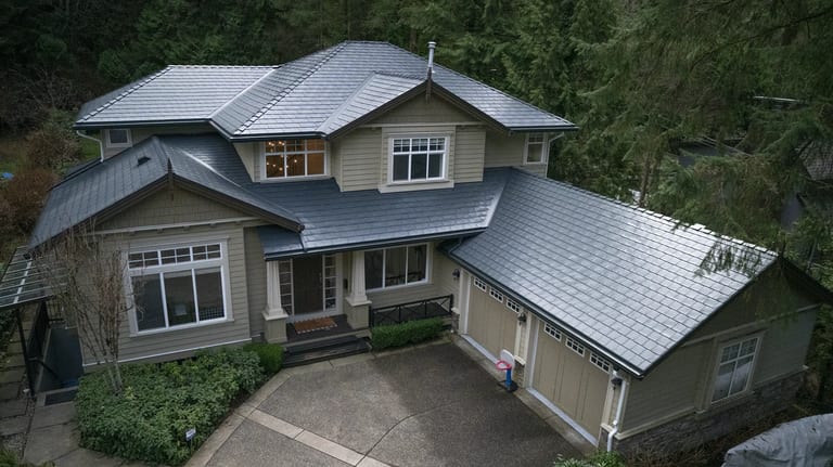 Deep Charcoal Interlock Slate aluminum roof on a modern home with a grey roof in a forested mountain, North Vancouver, British Columbia