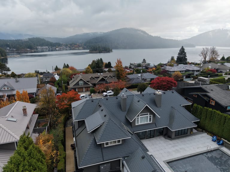 Deep Charcoal Interlock Slate aluminum roof on a dark home with dormers on a waterfront lot, North Vancouver, British Columbia