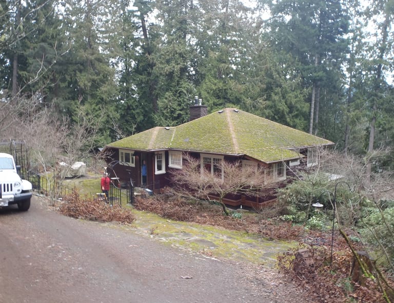 Before: Before: a leaking asphalt shingle roof on the home, Cowichan Bay, British Columbia, ahead of a Copper Penny Interlock Slate aluminum roof