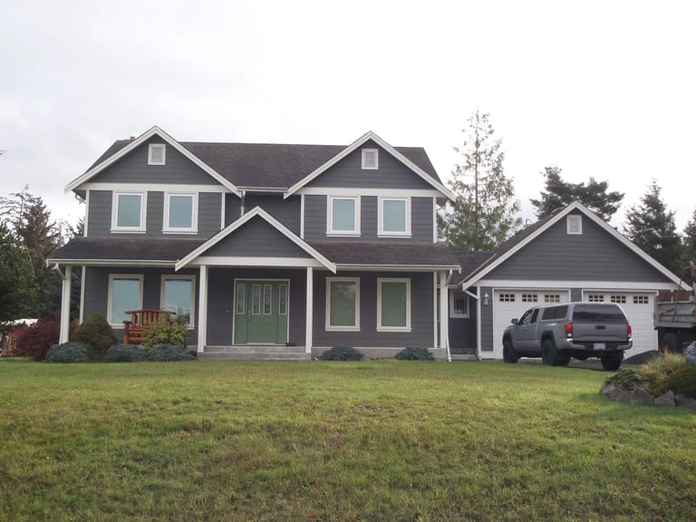 Before: Before: a leaking asphalt shingle roof on the home, Sooke, British Columbia, ahead of a Black Interlock Slate aluminum roof