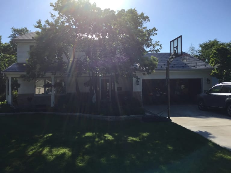 Black Interlock Slate aluminum roof on a white Colonial home with a metal roof in a suburban, Batavia, Illinois