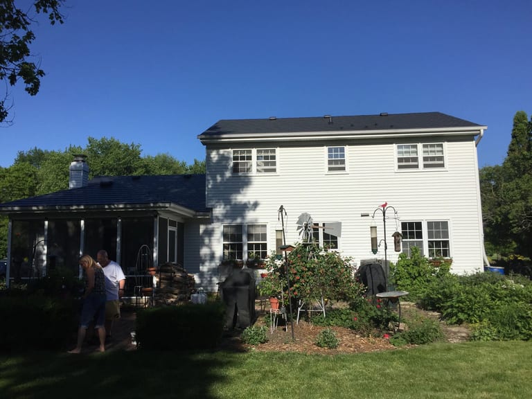 Black Interlock Slate aluminum roof on a white two-storey home with dormers in a residential area, Batavia, Illinois