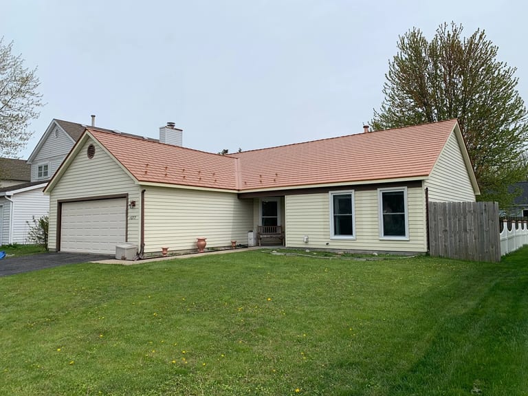 Copper Penny Interlock Cedar Shingle aluminum roof on a cream coloured single-storey ranch home with a copper, Bolingbrook, Illinois