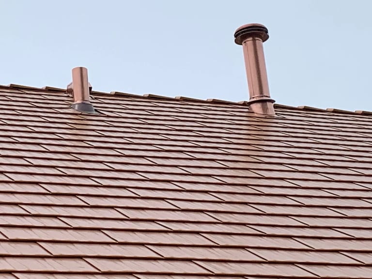 Copper Penny Interlock Cedar Shingle aluminum roof on a brown single-family home with a copper penny roof in a, Bolingbrook, Illinois