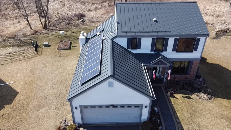 Deep Charcoal Interlock Standing Seam aluminum roof on a two-storey Colonial home with dormers in a rural setting, Carpentersville, Illinois