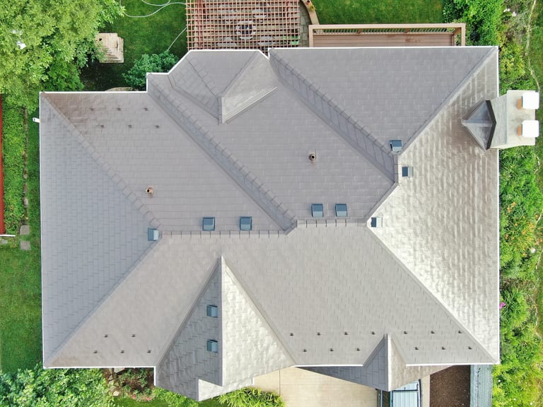 Colonial Brown Interlock Slate aluminum roof on a colonial style home with a metal roof in a wooded rural, Calredon Hills, Illinois
