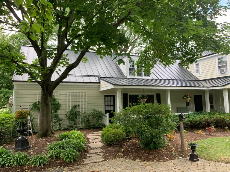 Black Interlock Standing Seam aluminum roof on a colonial home with a black metal roof, surrounded by, Lake Forest, Illinois