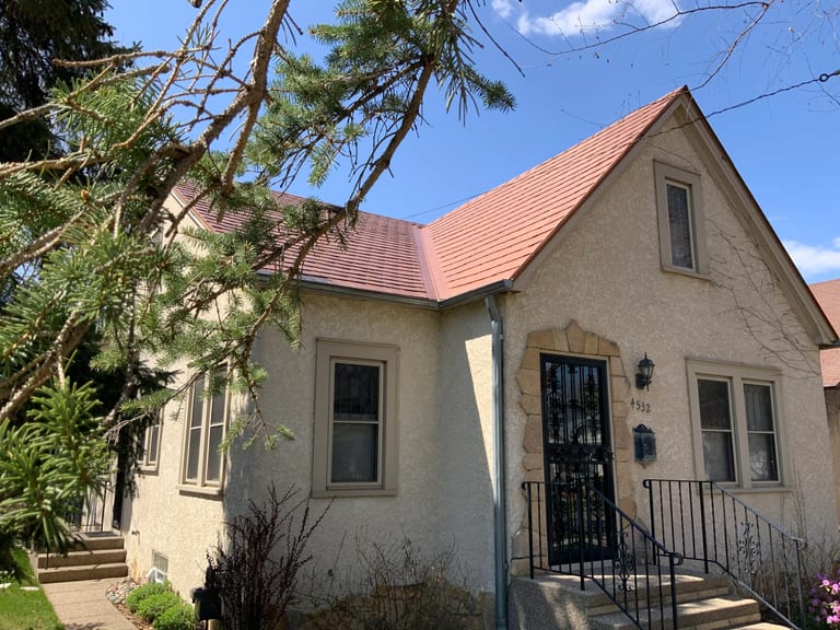 Aged Copper Interlock Slate aluminum roof on a cottage-style home with a red roof and a small front porch, Minneapolis, Minnesota