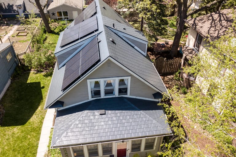 Deep Charcoal Interlock Slate aluminum roof on a grey single-family home with dormers in an urban/suburban, Minneapolis, Minnesota
