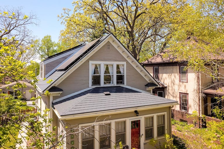 Deep Charcoal Interlock Slate aluminum roof on a two-storey colonial home with a metal roof in a forested, Minneapolis, Minnesota