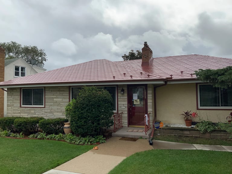 Tile Red Interlock Slate aluminum roof on a cream two-storey home with dormers in an urban/suburban, St. Paul, Minnesota