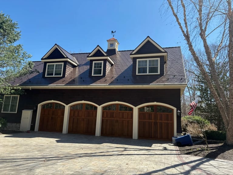 Colonial Brown Interlock Slate aluminum roof on a brown Colonial home with two-car garage in a wooded rural, Concord, New Hampshire