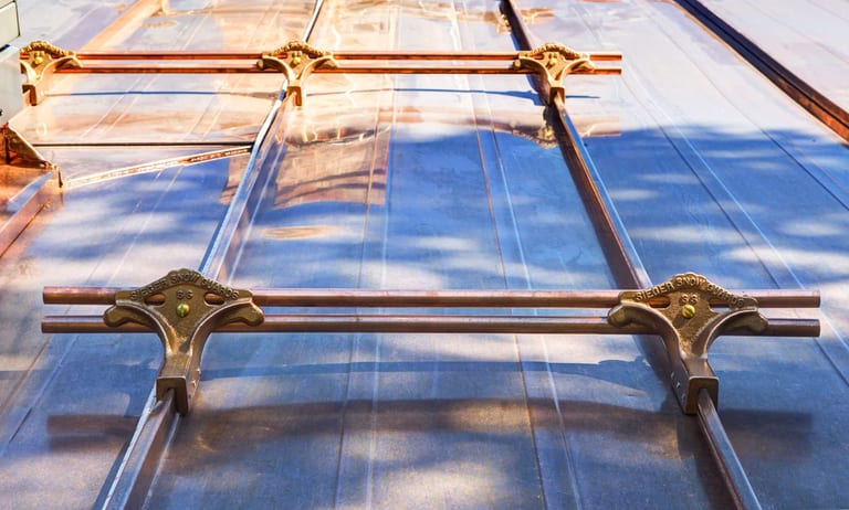Solid copper Interlock Standing Seam roof on a one-storey home with a hip roof in a rural setting, Antigonish, Nova Scotia