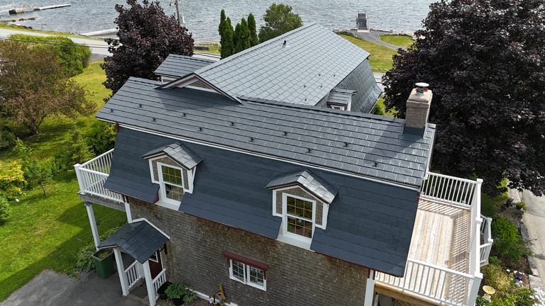 Deep Charcoal Interlock Slate aluminum roof on the home with roof louver and chimney, East LaHave, Nova Scotia