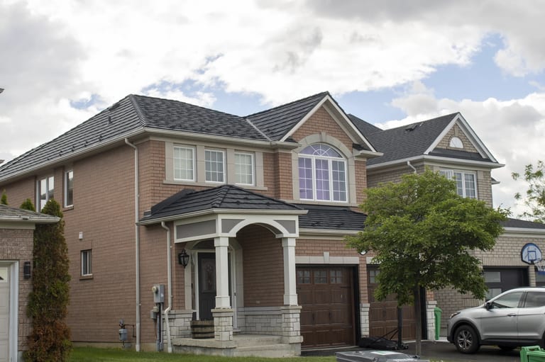 Black Interlock Shake aluminum roof on a two-storey brick home with a metal roof in a suburban, Mississauga, Ontario