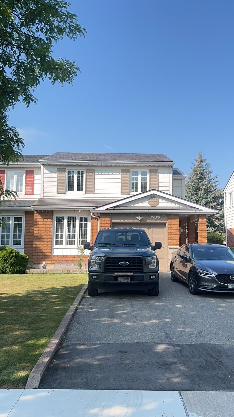 Two-storey Colonial home in Mississauga with Interlock Musket Grey aluminum slate metal roofing, brick facade, and attached garage.